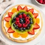 Sweet fruit pizza with strawberries kiwi blueberries on sugar cookie crust