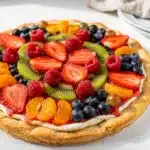 Colorful fresh fruit pizza on sugar cookie crust with creamy vanilla cream cheese spread