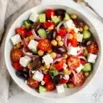 Colorful Greek chickpea salad with feta, olives, and lemon oregano dressing.