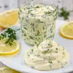 Close up overhead view of vibrant green lemon herb mayonnaise recipe in bowl