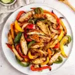 Juicy sheet pan chicken fajitas with charred peppers and warm tortillas