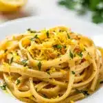 Creamy lemon garlic pasta recipe with spaghetti, fresh parsley, and parmesan cheese.