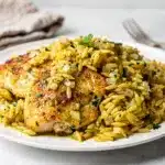 Creamy lemon herb orzo with golden brown chicken in one pan meal