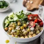 Lemon herb quinoa bowl with chickpeas cucumber tomatoes and feta cheese