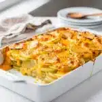 Creamy make ahead scalloped potatoes with golden cheese crust in baking dish