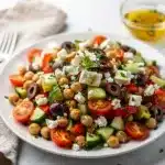 Make ahead Mediterranean chickpea salad with feta and fresh vegetables.
