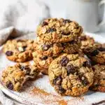 Oatmeal raisin cookies with crispy edges and chewy centers on rustic board