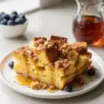 Golden brown overnight French toast bake with caramelized crust and blueberries.