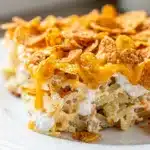 Creamy crockpot hashbrown casserole with crispy golden cornflake topping.