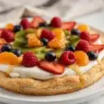 Seasonal fruit pizza sugar cookie with cream cheese frosting and fresh berries