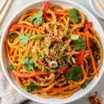Creamy sesame noodle salad with fresh vegetables and toasted sesame seeds.