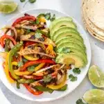 Easy sheet pan chicken fajitas with peppers and onions for a quick dinner.