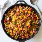 Skillet turkey taco rice with melted cheese and crispy edges close up
