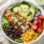 Colorful Southwest chicken salad bowl with grilled chicken and creamy avocado.