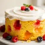 Vibrant seasonal jello poke cake with strawberry gelatin and whipped cream frosting