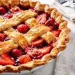 Seasonal strawberry pie with ruby red filling and flaky golden lattice crust