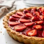 Make ahead strawberry pie slice with glistening red filling and flaky crust.