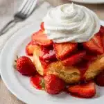 Sweet strawberry shortcake with flaky biscuit, fresh berries, and whipped cream.