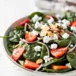 Fresh strawberry spinach salad with feta cheese and almonds in poppy seed dressing.