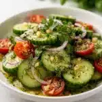 Refreshing summer cucumber salad recipe with vibrant tomatoes and fresh herbs.