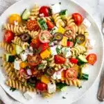 Colorful summer pasta salad with creamy herb dressing and fresh vegetables