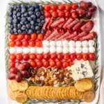 Patriotic charcuterie board with red white and blue ingredients for July Fourth.