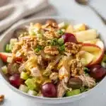 Apple grape chicken salad with walnuts and creamy honey mustard dressing in bowl