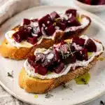 Vibrant beet goat cheese bruschetta appetizer with creamy cheese on toast