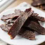 Beginner beef jerky recipe for homemade dark glossy marinated meat strips