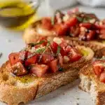 Classic tomato bruschetta recipe with fresh basil on toasted rustic bread