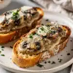 Creamy mushroom bruschetta with parmesan on toasted rustic baguette slices