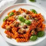 Creamy tomato pasta with sausage in a one pot make ahead meal.