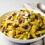 Creamy curry chicken salad with cranberries and almonds in a bowl.