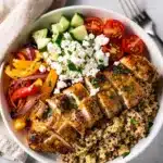 Fresh chicken meal prep bowl with quinoa and colorful roasted vegetables