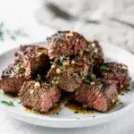 Tender garlic butter steak bites in cast iron skillet