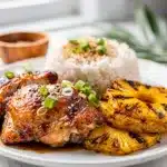 Glossy Huli Huli chicken with pineapple soy glaze on board.
