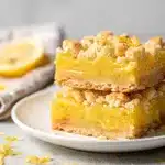 Golden brown lemon crumb bars with buttery shortbread crust