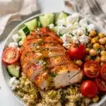 Easy chicken meal prep bowls with quinoa, fresh veggies, and lemon herb dressing.
