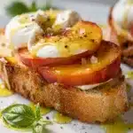 Creamy burrata and juicy peach bruschetta on toasted rustic bread close up