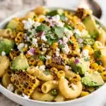 Creamy street corn pasta salad with cotija and avocado.