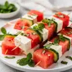 Refreshing watermelon feta skewers with cucumber mint and lime dressing.