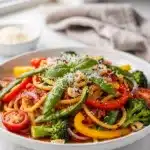 Vibrant zucchini noodle primavera with glossy tomato basil sauce