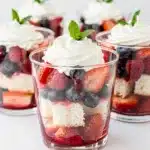 Angel Food Berry Cups with strawberries blueberries whipped cream mint.