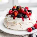 Fresh Berry Pavlova with glossy jam and crisp meringue