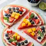 Vibrant watermelon pizza topped with creamy honey lime cream cheese